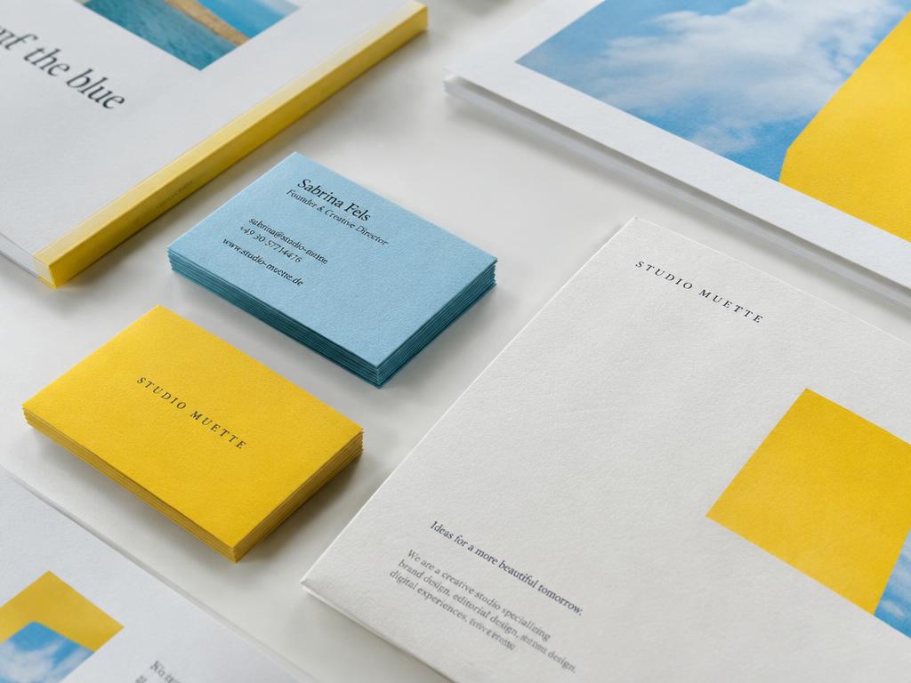 Premium printed business cards and brand stationery in yellow and sky blue